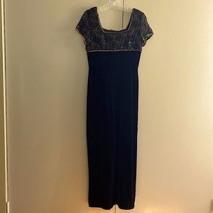 Long black formal gown with beads and gold trim at the top